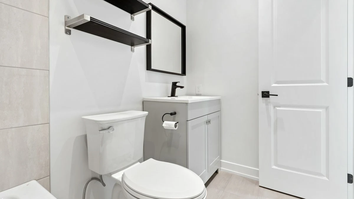 A compact bathroom with a white toilet directly beside a grey sink vanity, the short distance between them being what a warm-water attachment needs