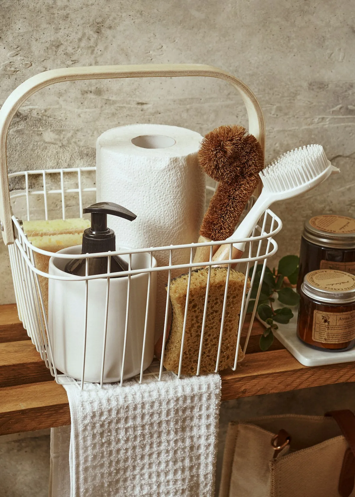 A bright clean bathroom with cleaning supplies arranged neatly beside a modern toilet with a bidet seat