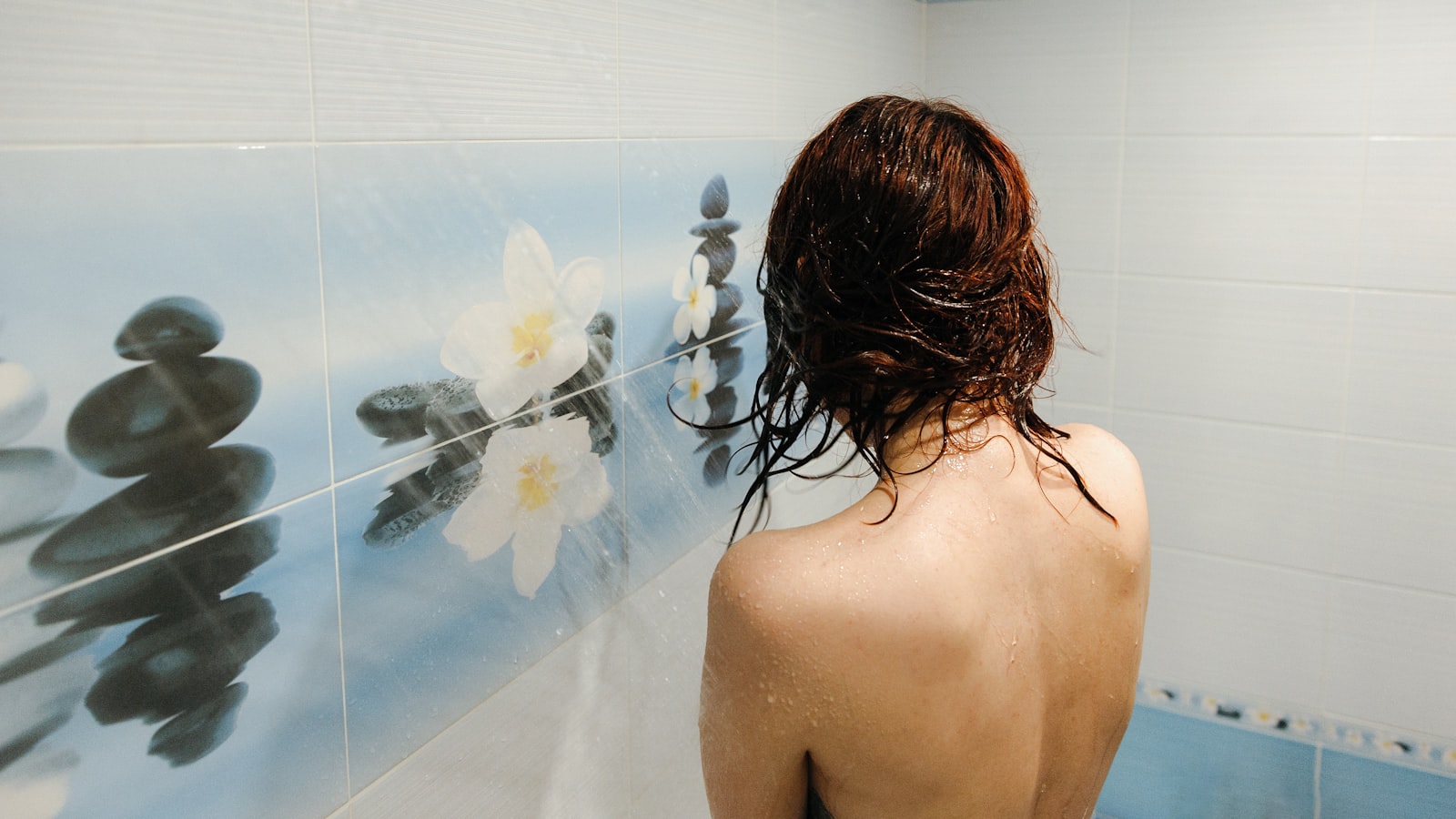 Steam rising from a bathtub tap showing warm water flow