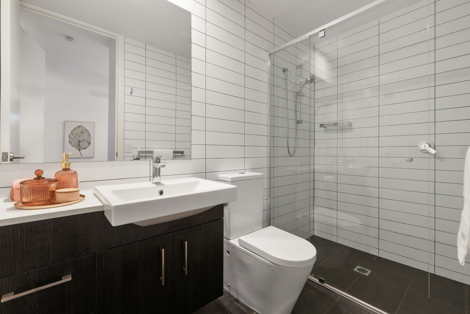 Clean modern bathroom with a white toilet ready for a bidet attachment installation
